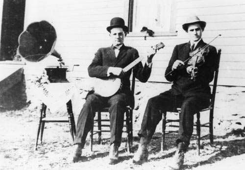 Unidentified banjo player and fiddler with phonograph machine, circa 1920s. Franklin County, Virginia.  
