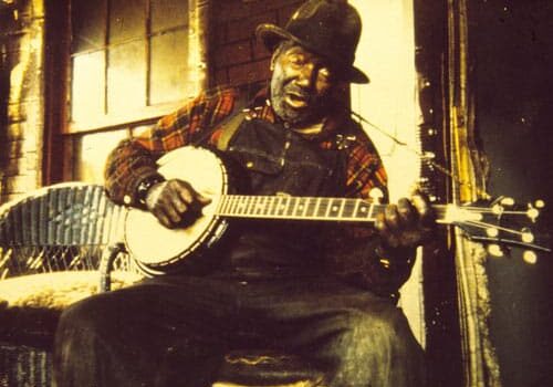 Josh Thomas playing banjo at his home in 1969.  Hollins, Virginia.  Photo by Clifford Endres. 
<br> (Blue Ridge Heritage Archives, Ferrum College)